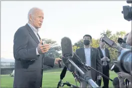  ?? SUSAN WALSH — THE ASSOCIATED PRESS ?? President Joe Biden talks with reporters after landing on Marine One on the South Lawn of the White House in Washington.