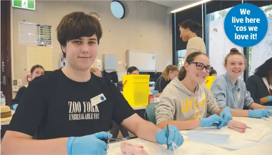  ?? Picture: Michael Nolan ?? SHARP MINDS: Learning to suture a pig’s foot at the University of Queensland Rural Clinical School 2020 school work experience program are (from left) Tom Head from Concordia College, Millicent O'Hagan from Toowoomba Christian College and Lauren Denman from St Ursula's College.