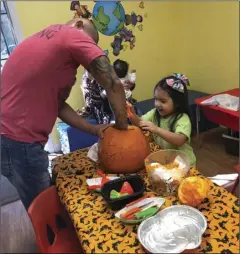  ??  ?? Alexa and her dad carving a Jack-O-Lantern at Discovery Land Preschool. PHOTO COURTSEY OF LULU BONNILA