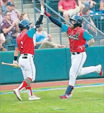  ?? [BROOKE LAVALLEY/DISPATCH] ?? Eric Haase of the Clippers gets a high-five from teammate Ka’ai Tom after hitting a home run in the third inning. Haase added a two-run blast in the sixth inning to give him 23 homers on the season.