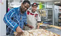  ??  ?? Community worker Howard Johnson prepares jerk chicken as part of a cooking class at the NDG Food Depot while client Joey Fontaine looks on.