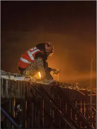  ?? ?? A worker assists Tuesday in the constructi­on of a bridge that will connect Sonamarg to Nilgrar Tunnel.