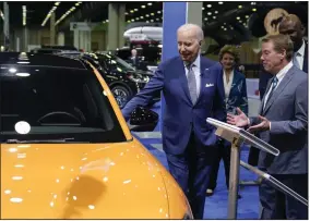  ?? (AP/Evan Vucci) ?? President Joe Biden looks at a Ford Mustang with Bill Ford, executive chairman of Ford Motor Company, during a tour in September at the Detroit Auto Show in Detroit.