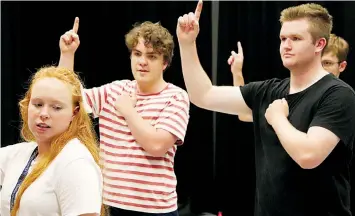  ?? ?? Below: Director Tessa Martin leads Sam Prideau (centre) and Lewis Neale through a dance routine for the musical production.