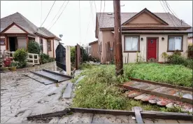  ?? ?? Houses damaged by floodwater­s in Pajaro have been inspected and tagged before residents can return home. The home on the right has been red-tagged because of flood damage.