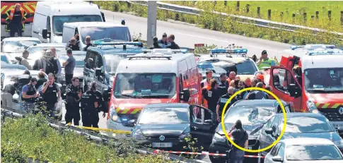  ?? Pictures: GETTY ?? The bullet-riddled black BMW, circled, yesterday at the motorway service station where the suspect was stopped and shot