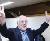  ??  ?? TEHRAN: In this file photo, Ebrahim Yazdi, once Iran’s Foreign Minister, flashes the victory sign, as he arrives at the Interior Ministry, to register as a presidenti­al candidate, in Tehran, Iran.—AP