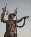  ??  ?? A statue in Basra symbolises the fight against ISIS