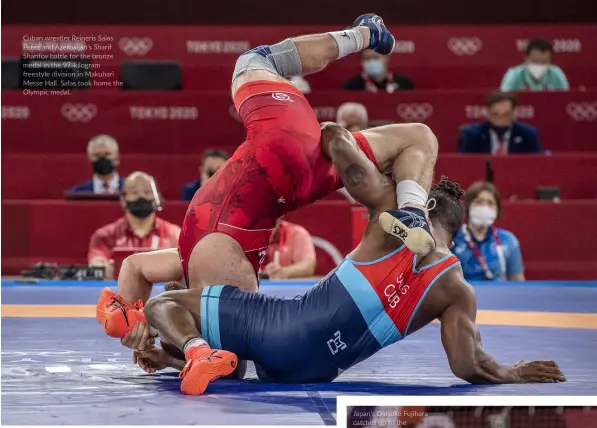  ?? ?? Cuban wrestler Reineris Salas Perez and Azerbaijan's Sharif Sharifov battle for the bronze medal in the 97-kilogram freestyle division in Makuhari Messe Hall. Salas took home the Olympic medal.