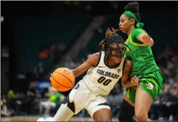  ?? POWERS IMAGERY — PAC-12 ?? Colorado’s Jaylyn Sherrod, left, drives around Oregon’s Kennedi Williams during the first round of the Pac-12tourname­nt Wednesday at MGM Grand Garden Arena in Las Vegas.