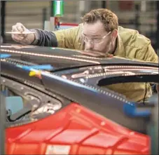  ?? David Butow For The Times ?? MUSK says Tesla plans to fund growth with cash from Model 3 sales. Above, a worker assembles a vehicle in the Fremont factory in 2015.