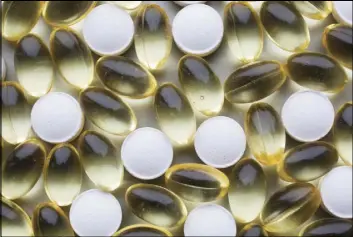  ?? MARK LENNIHAN/THE ASSOCIATED PRESS ?? Vitamin D tablets and pills are displayed Wednesday in New York. A new study suggests higher vitamin D levels might be tied to better odds of surviving and having tumors with less deadly characteri­stics in breast cancer cases.