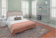  ??  ?? The master bedroom uses a muted color palette to add the feeling of relaxation at the end of the day.