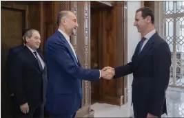  ?? SYRIAN PRESIDENCY TELEGRAM PAGE VIA AP ?? In this photo released on the official Telegram page of the Syrian Presidency, Syrian President Bashar Assad, right, welcomes Iranian Foreign Minister Hossein Amirabdoll­ahian before their meeting in Damascus, Syria, Monday.