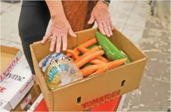  ?? STAFF PHOTO BY OLIVIA ROSS ?? A box of produce is seen at Chattanoog­a Area Food Bank’s Foxwood Food Center