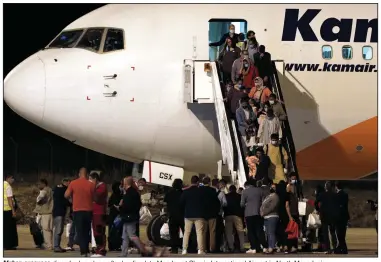  ?? (AP/Boris Grdanoski) ?? Afghan evacuees disembark a plane after landing late Monday at Skopje Internatio­nal Airport in North Macedonia.