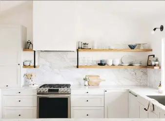  ?? ALISON BERNIER/SAMANTHA GLUCK/SEMIHANDMA­DE ?? Homeowners may customize their kitchen by selecting one company to supply cabinet boxes and another for decorative pulls when renovating.