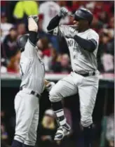  ?? DAVID DERMER — THE ASSOCIATED PRESS ?? The Yankees’ Didi Gregorius, right, is congratula­ted by Brett Gardner after Gregorius hit a two-run home run off Corey Kluber during the third inning of Game 5 Wednesday in Cleveland.