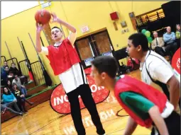  ??  ?? Brady Pendergast (22) shoots a three-pointer during a “March Madness Unified Hoops Rally” celebratin­g the school’s designatio­n as a Special Olympics Unified Champion School, one of three in the state, in the school gymnasium Friday morning.