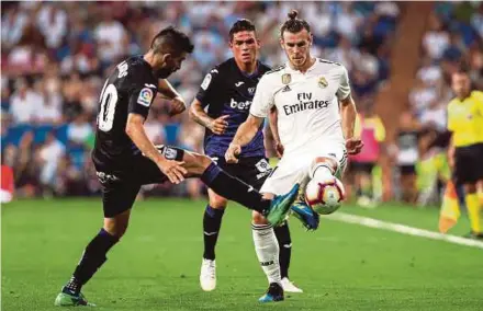  ?? EPA PIC ?? Real Madrid’s Gareth Bale (right) and Leganes’ Michael Santos vie for the ball in their La Liga match at the Bernabeu on Saturday.