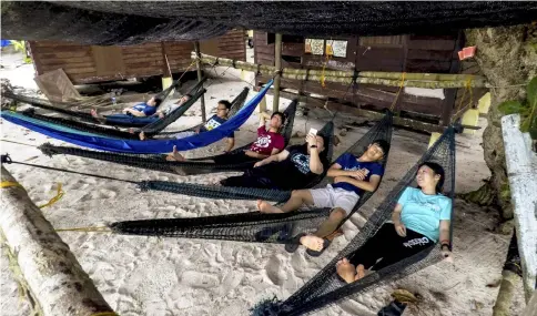  ??  ?? Volunteers taking a good rest at the Pantai Chagar Hutang.