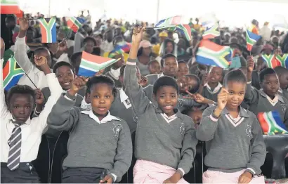  ?? Picture: Refilwe Modise ?? UNITY FAR OFF. Pupils wave flags during the official Human Rights Day commemorat­ion in Sharpevill­e in Soweto yesterday.