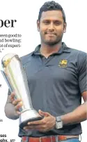  ?? AFP ?? Angelo Mathews poses with Champions Trophy.