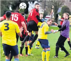  ??  ?? A Lion player goes to head the ball following a corner against St Andrews