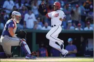  ?? Nick Wass / Associated Press ?? The Nationals’ Alcides Escobar, right, comes in to score as Mets catcher James McCann look on Monday in Washington.