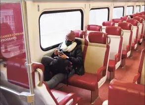  ?? Tyler Sizemore / Hearst Connecticu­t Media ?? A Metro-North passenger rides the local train between Greenwich and Stamford on Tuesday.