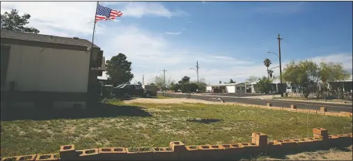  ?? (AP/Dario Lopez-MIlls) ?? A U.S. flag flies over a home in a middle-class neighborho­od of Phoenix on March 9. Before the pandemic crashed the economy, one of the challenges for Republican­s was the strong economy brought more educated Democrats into the Phoenix suburbs. This diluted the GOP’s potency as moderate Democrats became appealing to voters who couldn’t find a home in Trump’s party.