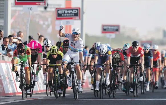  ?? Victor Besa / The National ?? Alexander Kristoff raises his hand in victory for UAE Team Emirates after winning a bunch sprint to the finish in Stage 1 of the Abu Dhabi Tour