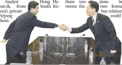  ??  ?? Officials of North and south shake hands on an agreement to improve relations yesterday