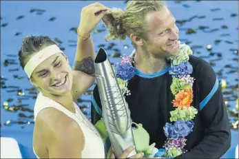  ?? XINHUA ?? Aryna Sabalenka of Belarus celebrates with her coach after winning the WTA Dongfeng Motor Wuhan Open on Saturday in Wuhan, Hubei province. Sabalenka defeated Estonia's Anett Kontaveit 6-3, 6-3 to claim her second title of the season.