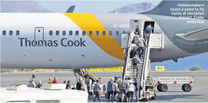  ??  ?? Holidaymak­ers board a plane to fly home at Heraklion Airport, Crete, yesterday