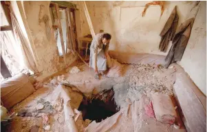  ?? — Reuters ?? A man inspects the damage in a house after a coalition air strike in old Sanaa city on Saturday.