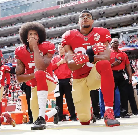  ?? THE ASSOCIATED PRESS/FILES ?? San Francisco 49ers quarterbac­k Colin Kaepernick and safety Eric Reid kneel during the national anthem before an NFL game against the Dallas Cowboys in 2016. The two have reached settlement­s on their collusion lawsuits against the NFL, the league said Friday.