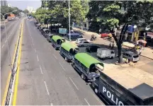  ??  ?? Police trucks are parked at Kyauktada police station in Yangon, Myanmar on Monday