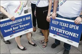  ?? RALPH BARRERA / AMERICAN-STATESMAN ?? IBM employees hold signs at the Capitol rally Monday. The technology giant took out newspaper ads Sunday objecting to the bathroom bill.