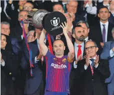  ?? AFP ?? Barcelona’s Andres Iniesta holds the Copa del Rey trophy