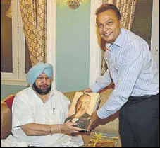  ?? HT PHOTO ?? Reliance ADAG head Anil Ambani presenting a book to Punjab chief minister Capt Amarinder Singh during their meeting in Mumbai on Tuesday.