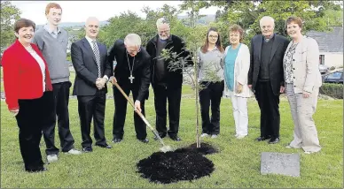  ??  ?? Bishop of Kerry Ray Browne planting a tree to mark the 40th anniversar­y celebratio­n of Tarbert Comprehens­ive School. Also in photo are, from left; Sr Frances, Day School Chaplin; Dan Mullane, Male Student of the Year; Richard Prendivill­e, Principal;...