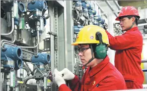  ?? CHEN YUANZI / FOR CHINA DAILY ?? Workers calibrate sensitive systems on board an oil exploratio­n project of CNOOC in Shanxi province.