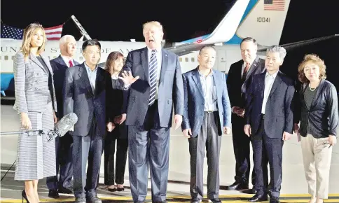  ?? — AFP photo ?? Trump (centre) speaks upon the arrival of Dong-chul (fourth right), Hak-song (second right) and Tony (third left) after they were freed by North Korea, at Joint Base Andrews in Maryland.