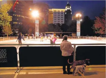  ?? PHOTO BY DOUG HOKE, THE OKLAHOMAN ?? People enjoy the Devon Ice Rink, one of the Downtown in December attraction­s, on Nov. 15, the first night it was open.