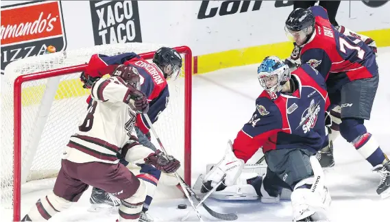  ?? JASON KRYK ?? The puck slips past Windsor Spitfires goaltender Mikey DiPietro during the first-period against the Peterborou­gh Petes at the WFCU Centre Thursday.