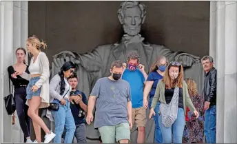  ??  ?? Tourists, some in face masks while others are not, visit the Lincoln Memorial in Washington. — AFP photo