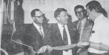  ??  ?? British Deputy High Commission­er Mr Bernard Carter, CMG, (second from left) discusses a length of fibre with manager of James Miller and Co. Pty Ltd.’s Warragul Mr R. Hutchison during an inspection of the factory last Friday. Listening intently to the discussion are Shire President Cr J.V. Crawford (left) and newly appointed Latrobe Valley Promotion Officer, Mr K. Rohan. Mr Carter was taken on an extensive tour of the district and was impressed with its developmen­t and potential.