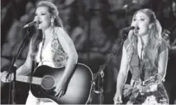  ??  ?? Tae Dye, left, and Maddie Marlow, who make up the group Maddie & Tae, scored the recent big hit “Girl in a Country Song.” Wade Payne, Invision