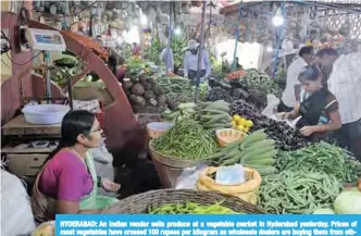  ??  ?? HYDERABAD: An Indian vendor sells produce at a vegetable market in Hyderabad yesterday. Prices of most vegetables have crossed 100 rupees per kilogram as wholesale dealers are buying them from other states due to recent rains that damaged crops in many parts of the southern Indian states of Telangana and Andhra Pradesh. —AFP